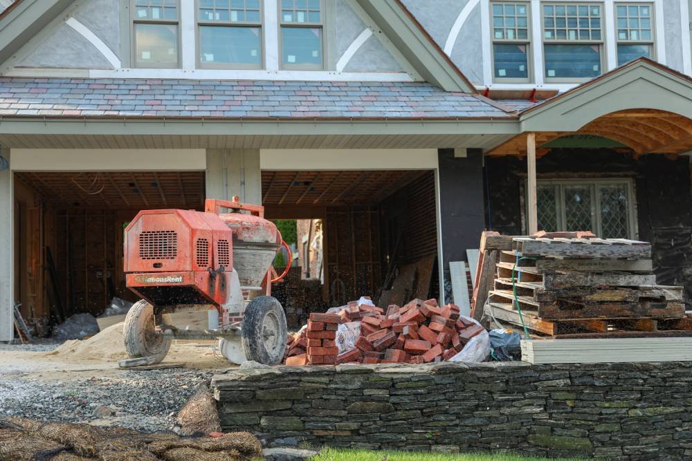 red-tractor-is-outside-house-that-has-been-shoveled-out-wood